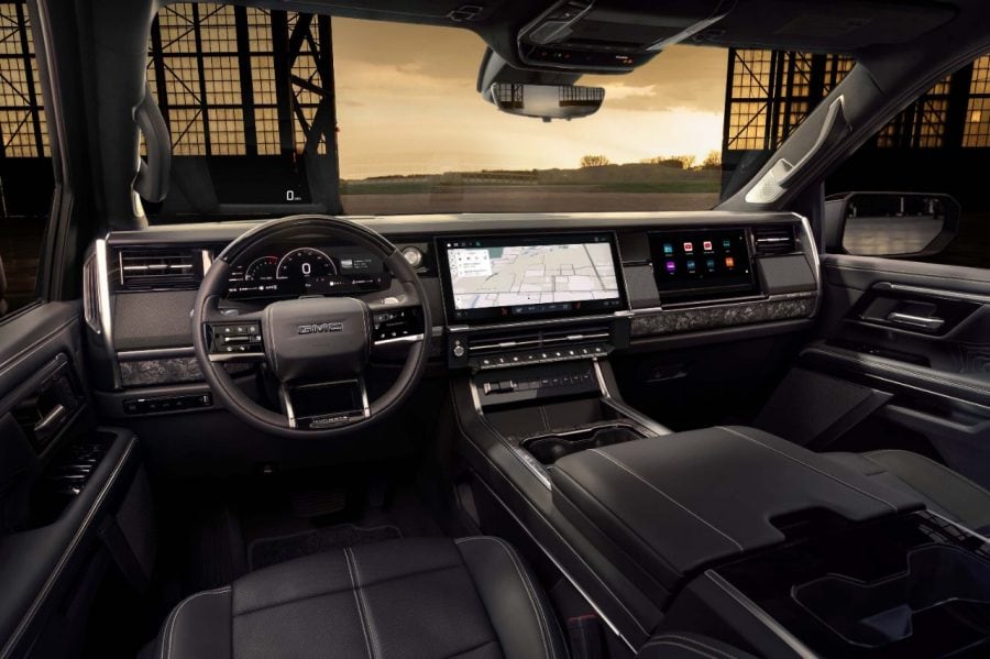 GMC truck dashboard with a digital instrument cluster, central navigation screen and passenger screen.