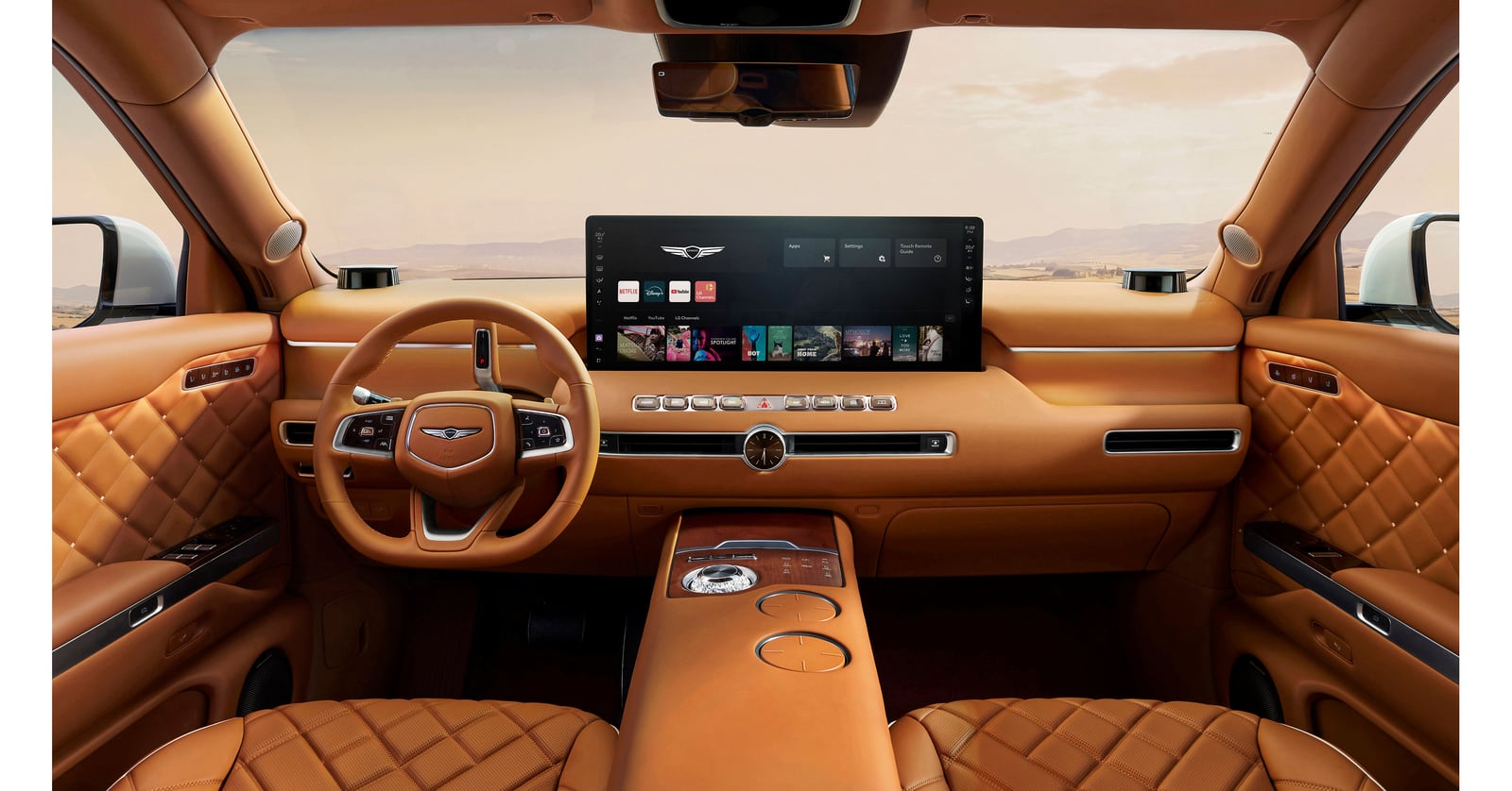 Genesis cabin with tan leather seats and a raised dashboard screen showing streaming apps.